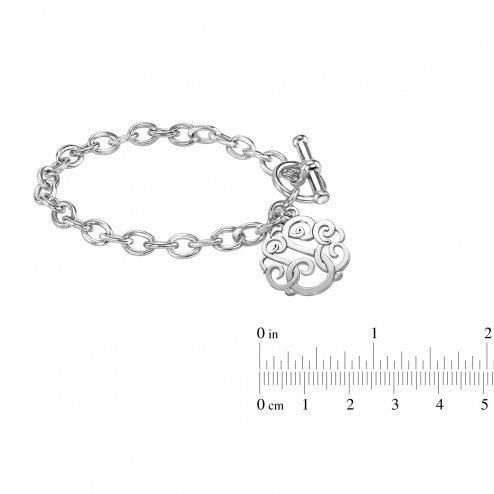 Silver bracelet with a decorative charm and measurement scale on a white background