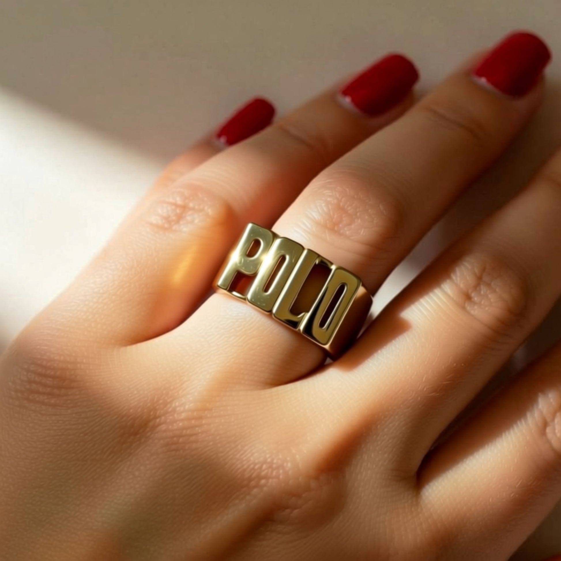 Large Block Gold Name Ring on a womans hand