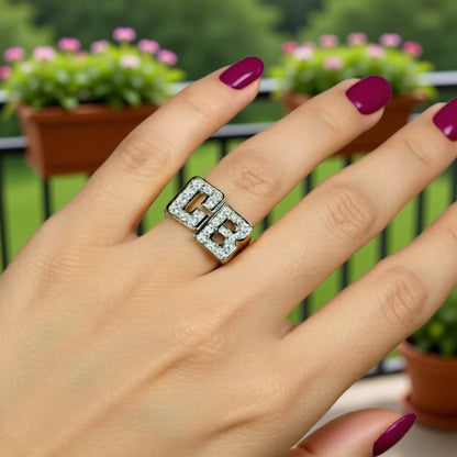 diamond initial ring on a hand
