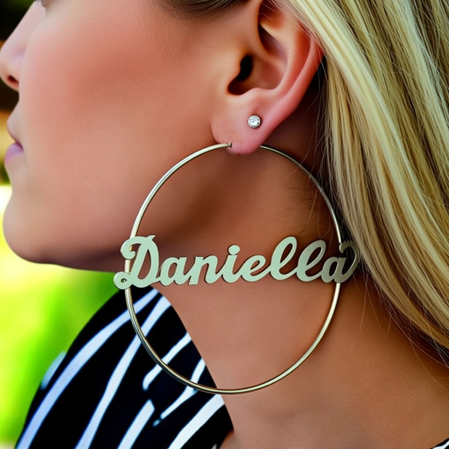 extra large name hoop earrings on a person