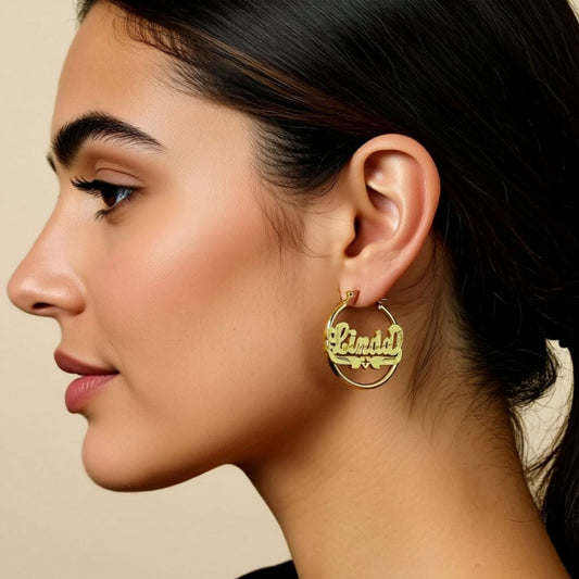 Diamond Cut Name Hoop Earrings on a person