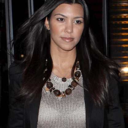 Kourtney Kardashian wearing engraved disc necklace