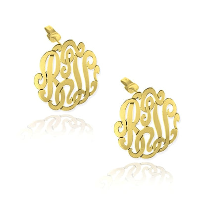 Gold monogram earrings on a white background