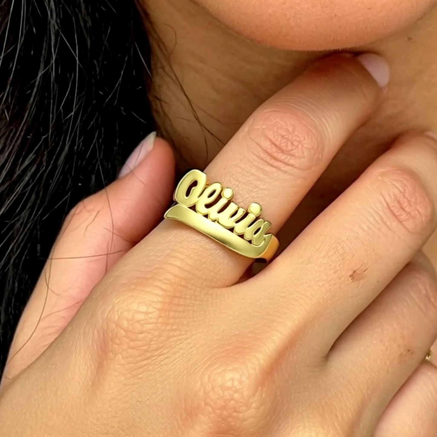 Gold Large Script Name Ring with Tail 9 on a hand