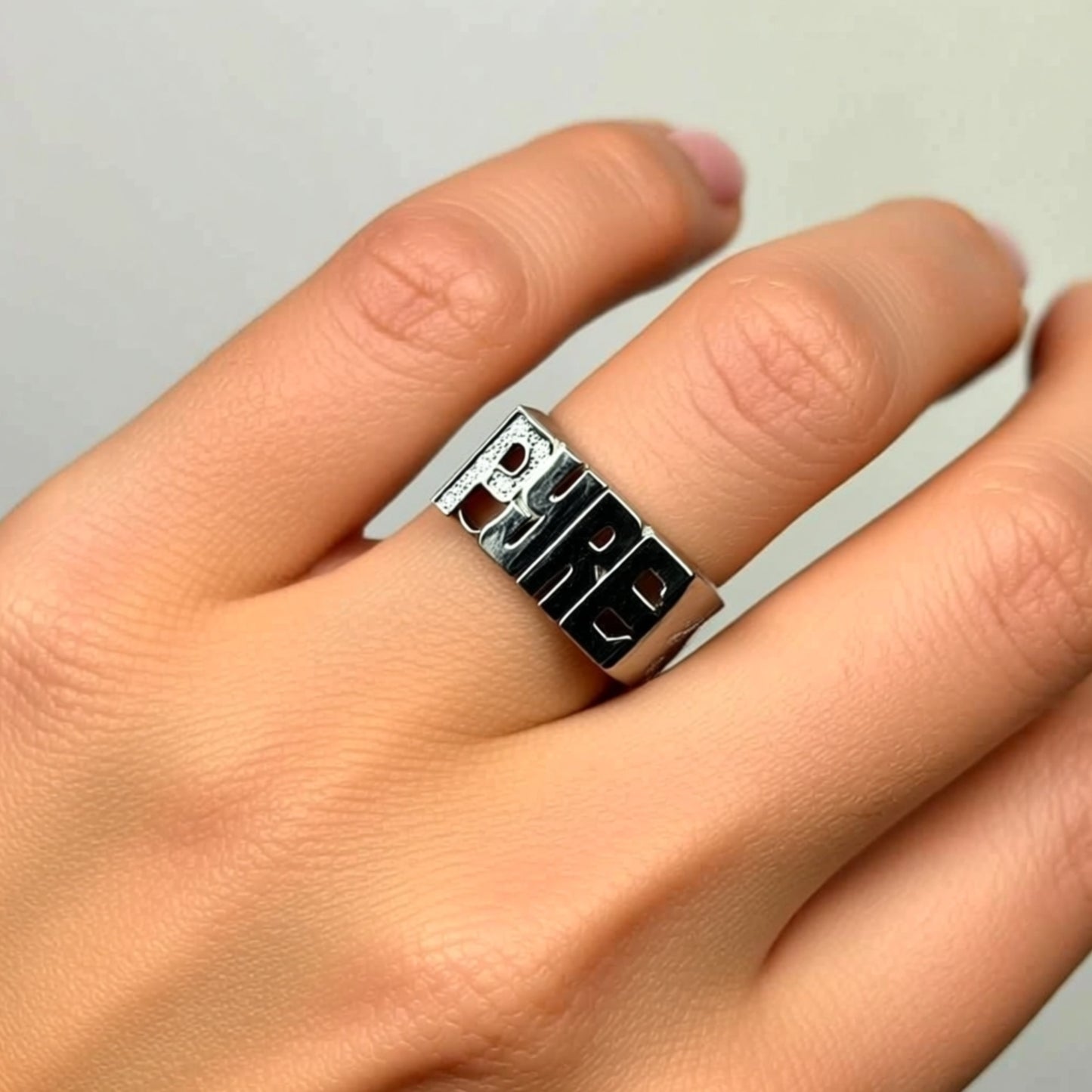 name ring with diamonds on a hand