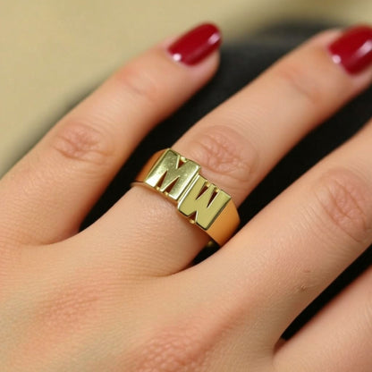 two initial ring on a hand